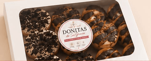 Box of Donitas de Su Gracia mini donuts ready for delivery